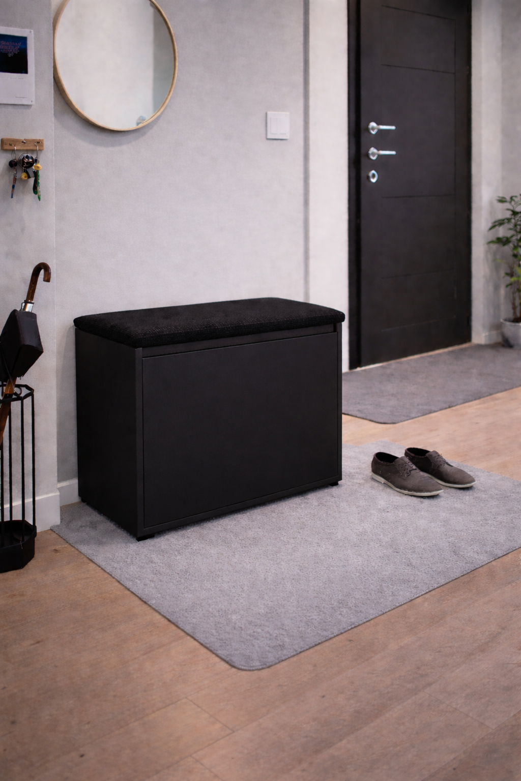 Czarna szafka na buty z siedziskiem i schowkiem do przedpokoju Lumo